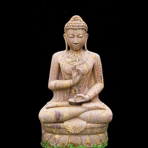 Serene sandstone Buddha statue showcasing peaceful meditation pose and spiritual craftsmanship